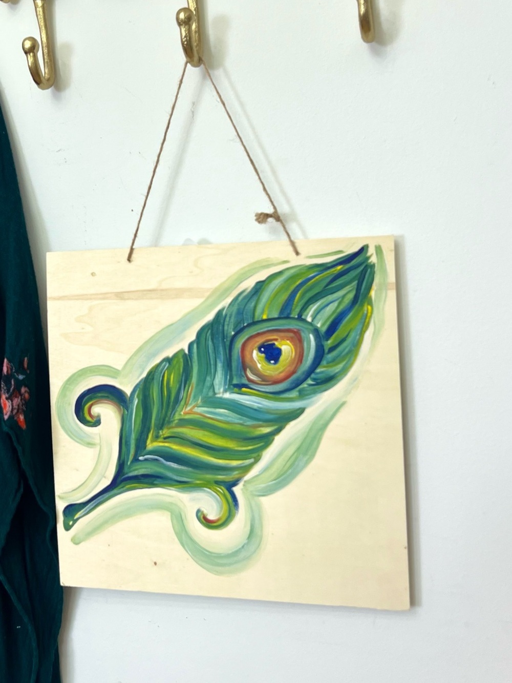 Peacock feather art on wood